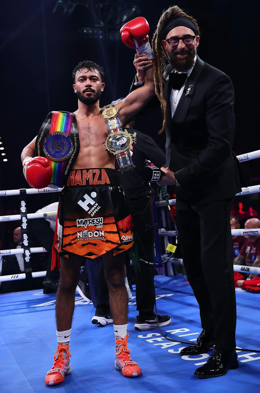 Boxer Hamza Uddin wearing MyFresh Active branded boxing shorts after a fight.